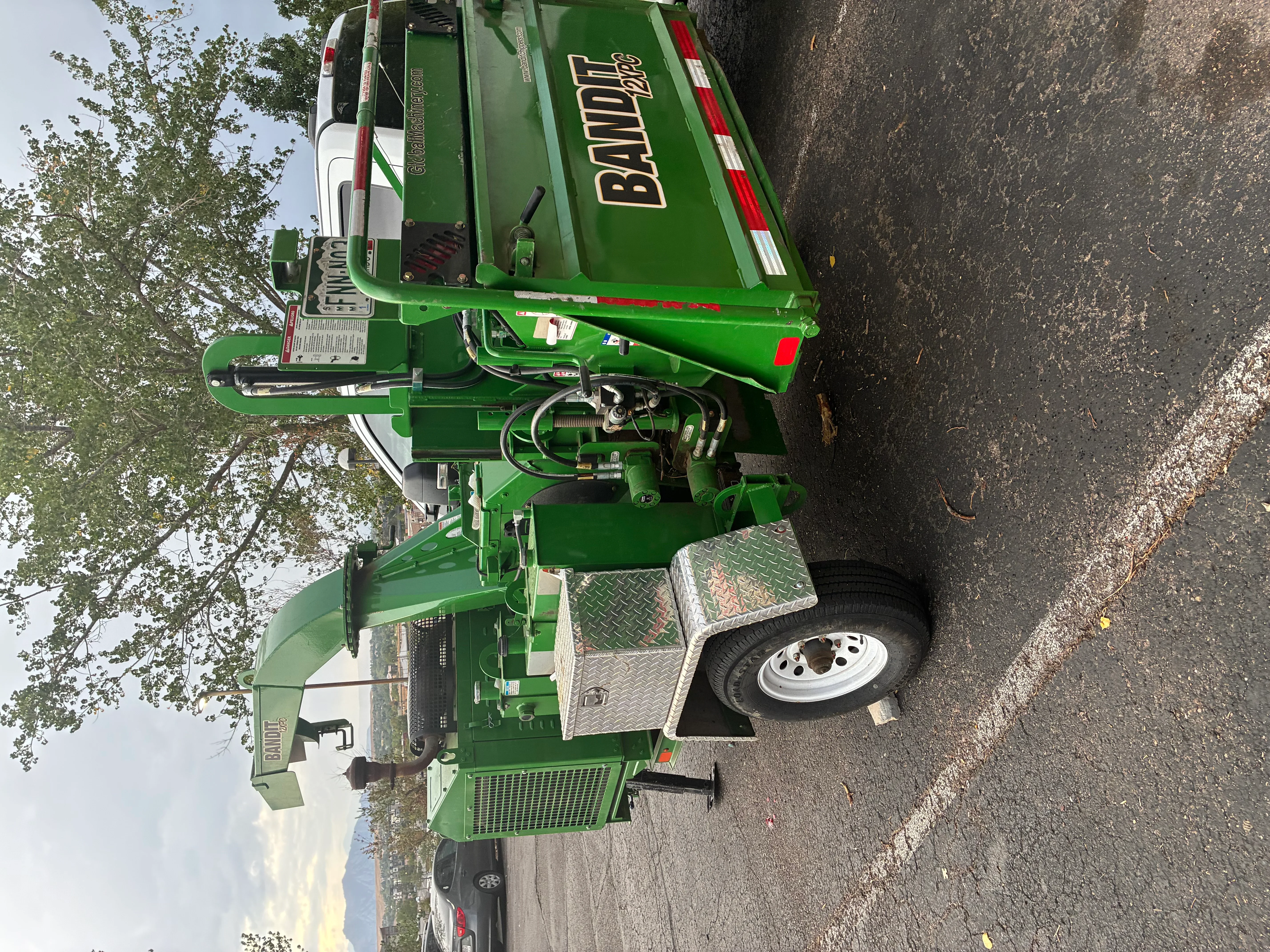 Green Bandit stump grinder with hydraulic system and diamond-plate platform