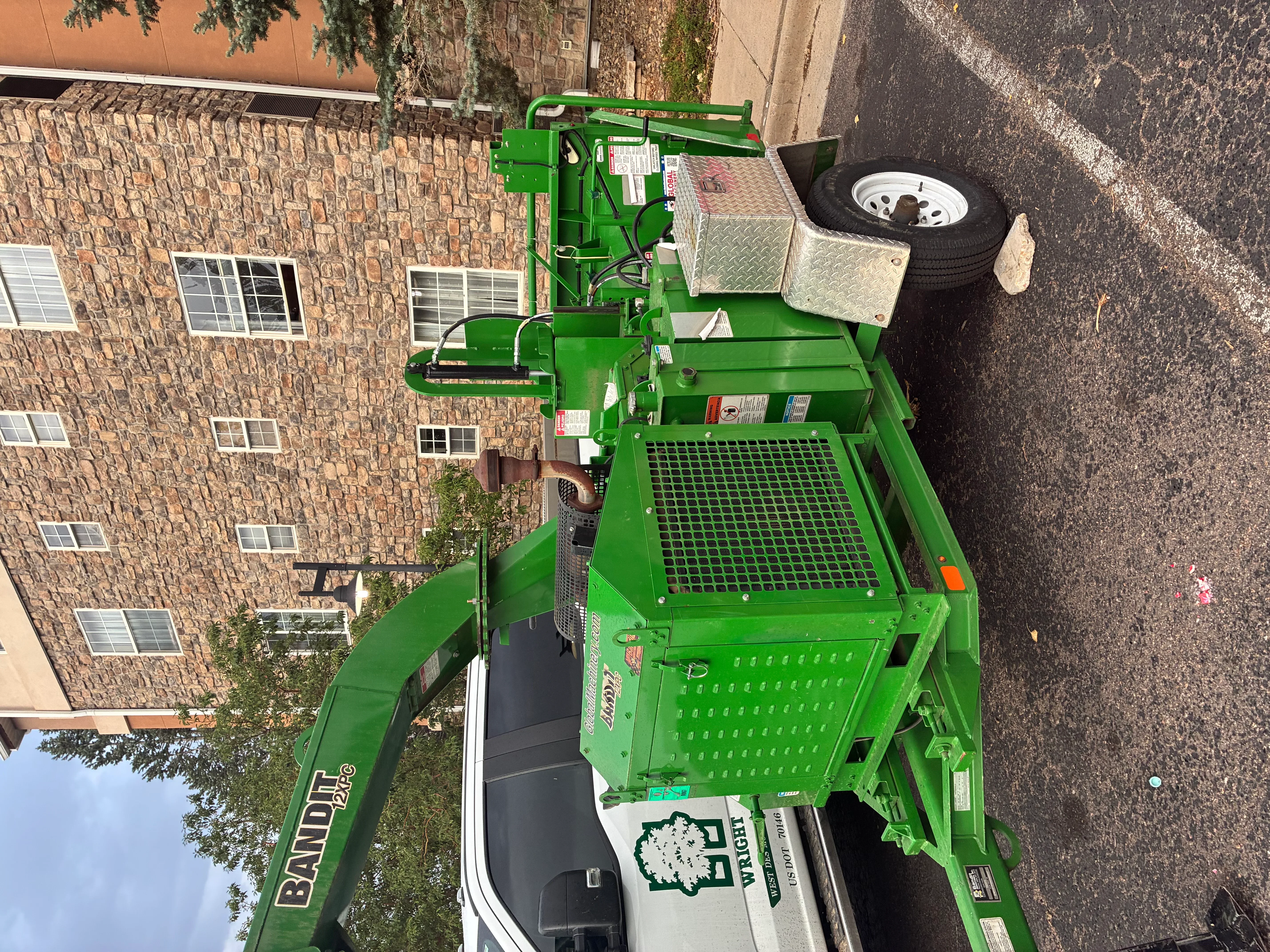 Green Bandit stump grinder with hydraulic arm and mesh screening platform