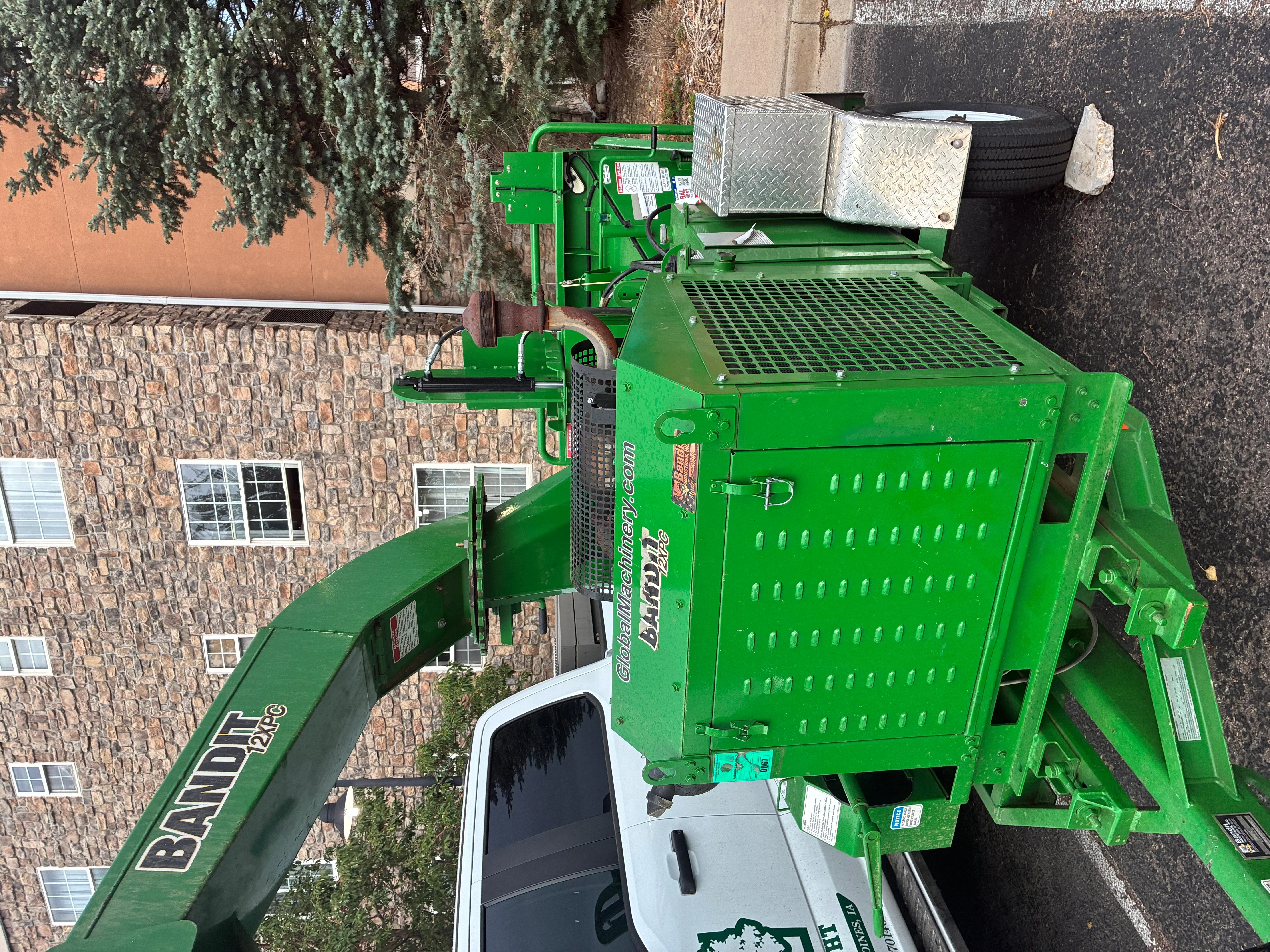 Green stump grinder with steel frame and grated platform for wood processing