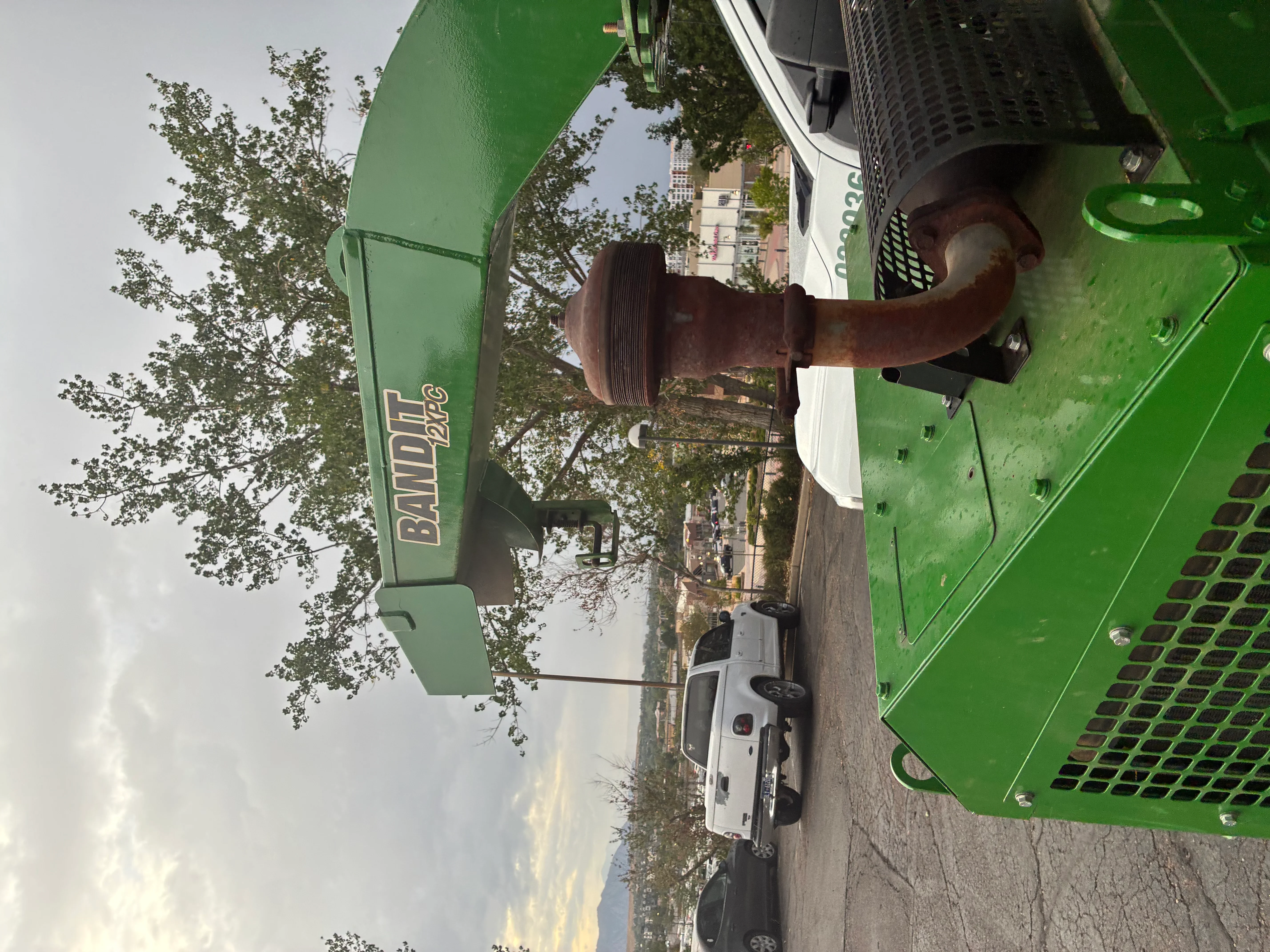 Green stump grinder equipment removing large tree stump with debris collection system
