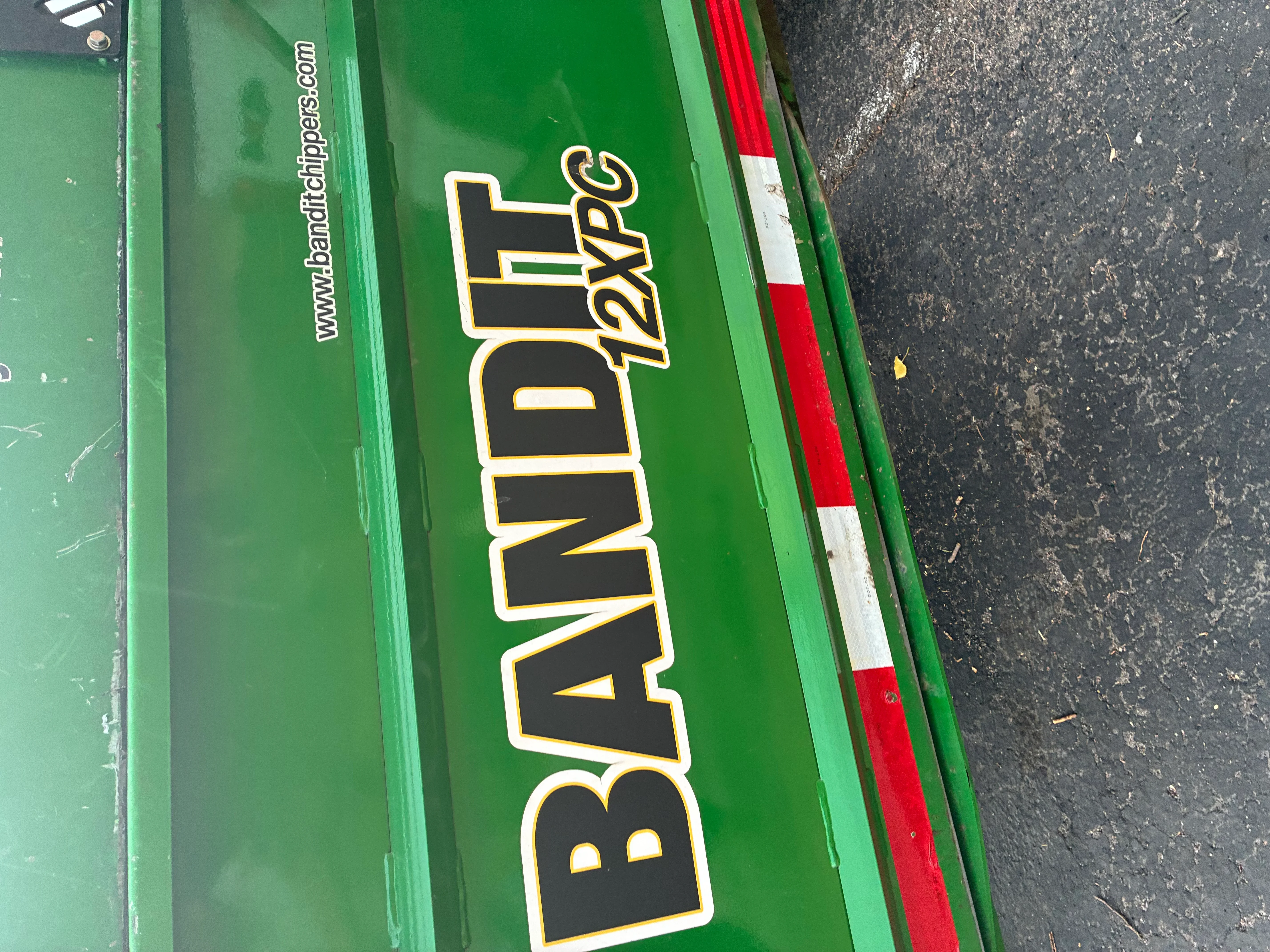 Green equipment with black vinyl lettering and gold/white outline, red and white safety stripe