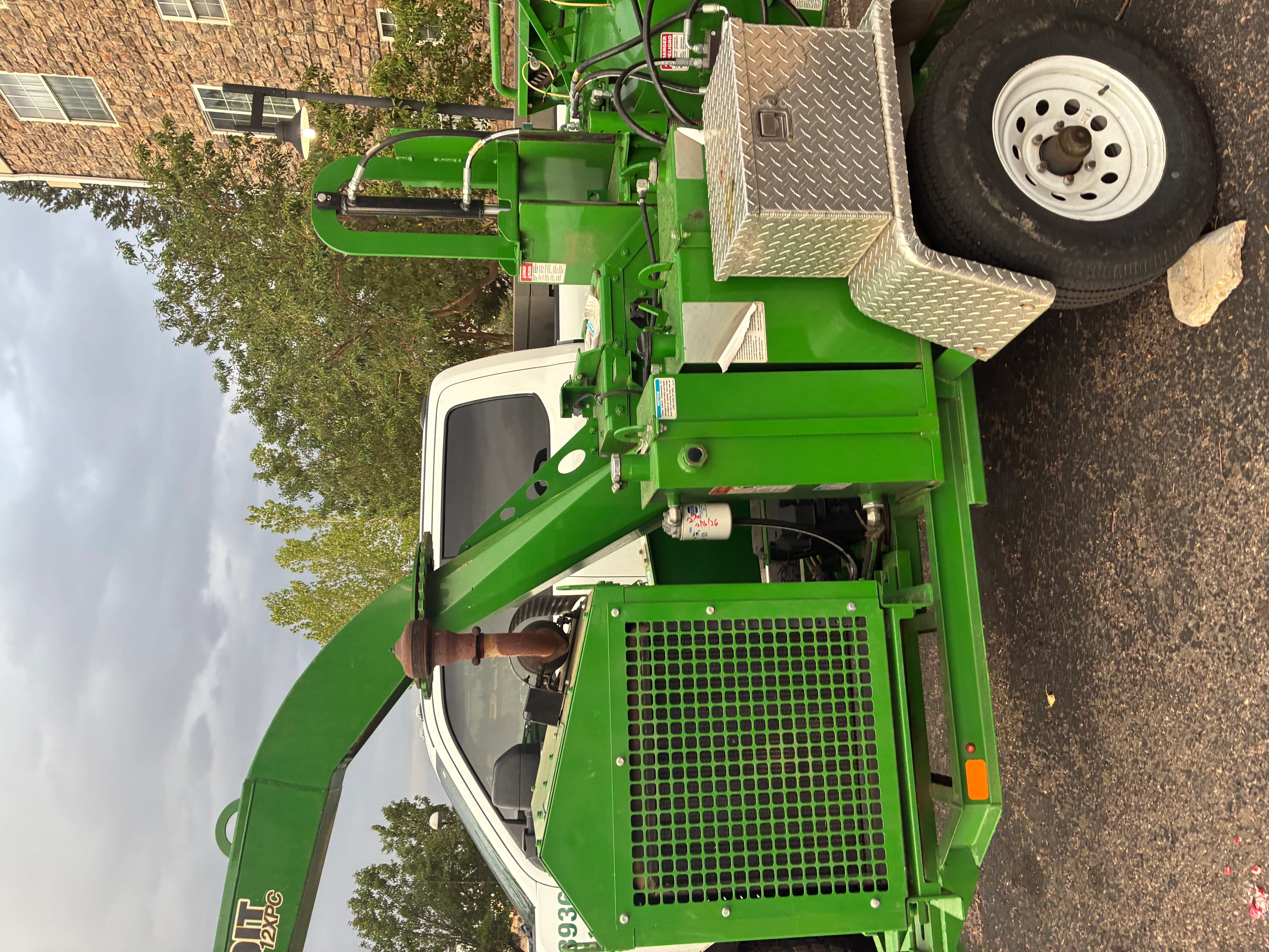 Green stump grinder with diamond-plate guards and industrial grinding head